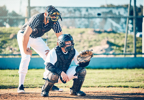 Sports, umpire and baseball with man on field for fitness, training and competition match. Strike, home run and catcher with athlete playing game in park stadium for league, pitchers and exercise