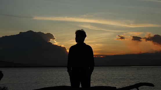 silhouette of man on the lake