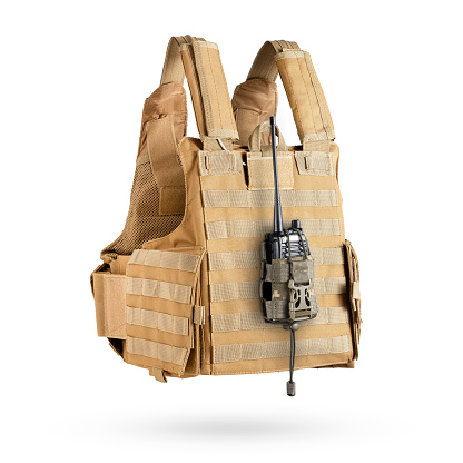 Bulletproof vest with tactical pouch in pixel camouflage with military radio inside. Military gear, equipment.