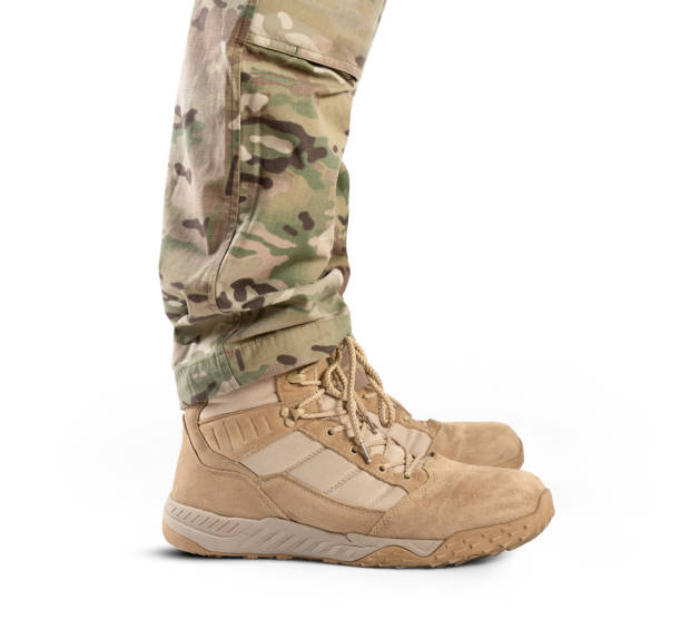 istock Soldier in military boots on a white background close-up. Army boots. 1551050246