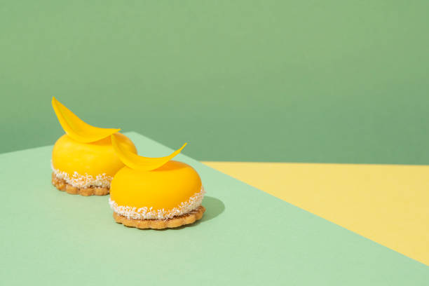 istock Two small yellow desserts sitting on a blue and yellow table 1551067664