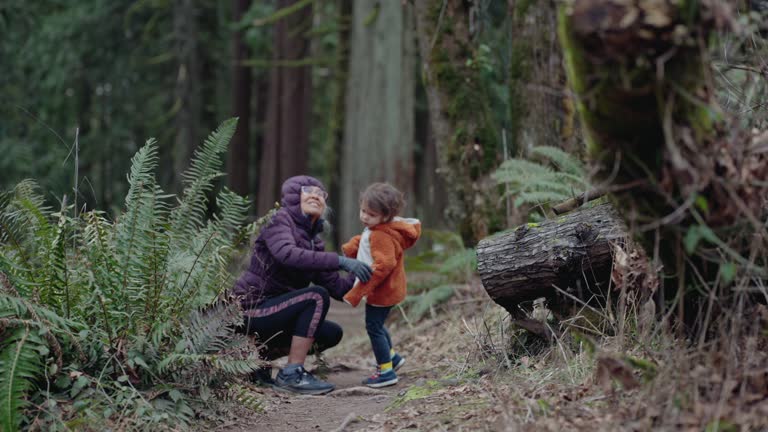 Active grandmother hiking with her preschool aged granddaughter