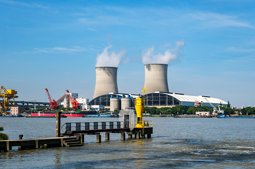 Duisburg, Rhineland, Germany, 09/15/2019 - steel plant with cooling towers on the banks of the river Rhine on a sunny day with blue sky