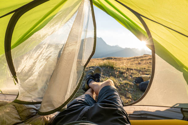 istock Man bikepacking and camping, POV from inside tent 1551152356