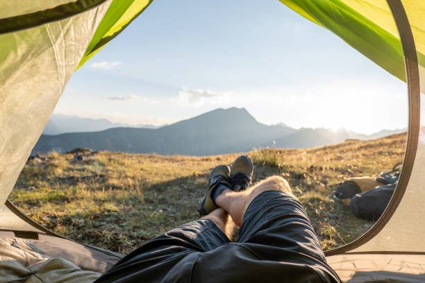 istock Man bikepacking and camping, POV from inside tent 1551152885