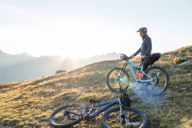istock Man mountain biking at sunset 1551159369