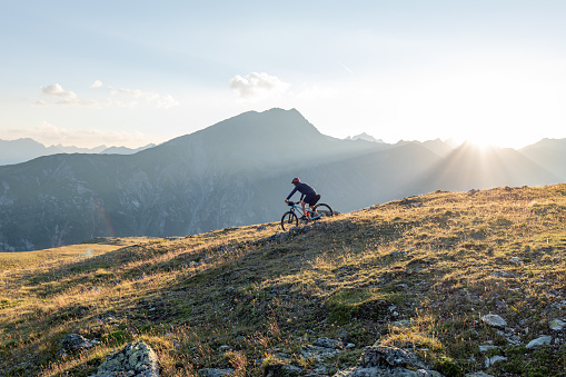 Man bikepacking, cycles along the trail to the next destination