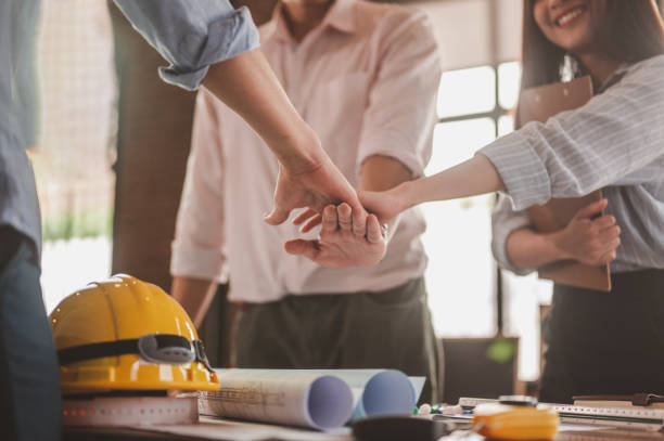 istock engineer and foreman clasp one hand for meet and brainstorm to prepare blueprint architect project. 1551178105