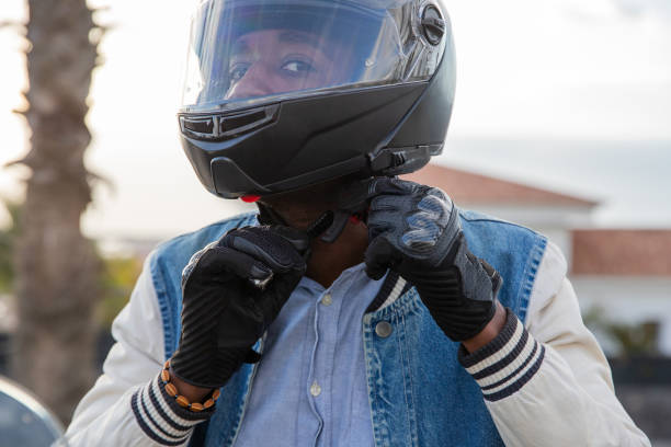 istock A motorcyclist tightens his helmet belt before driving his motorcycle 1551205693