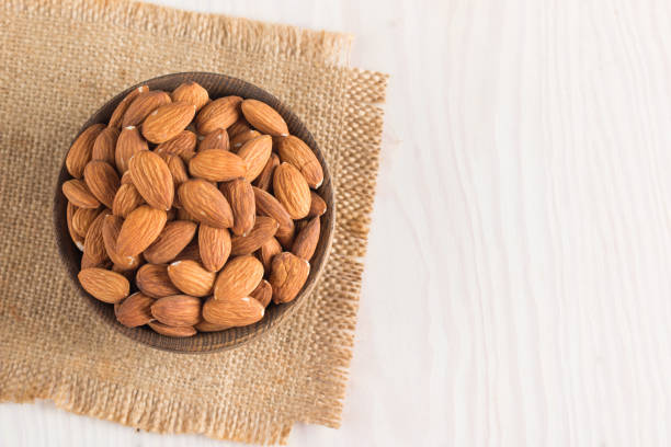 istock Raw peeled almonds in brown bowl 1551210322