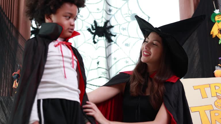 Family Fun Halloween - Joyful Mother and Child Enjoy Spooky Halloween Party at Home