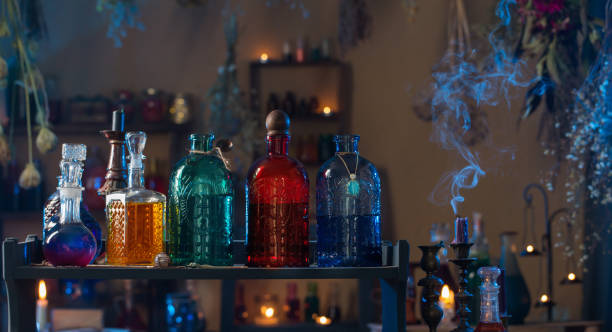 magic potions in witch's house with burning candles at night magic potions in witch's house with burning candles at night potion bottle retro revival old fashioned stock pictures, royalty-free photos & images