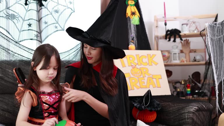 Family Fun Halloween - Joyful Mother and Child Enjoy Spooky Halloween Party at Home