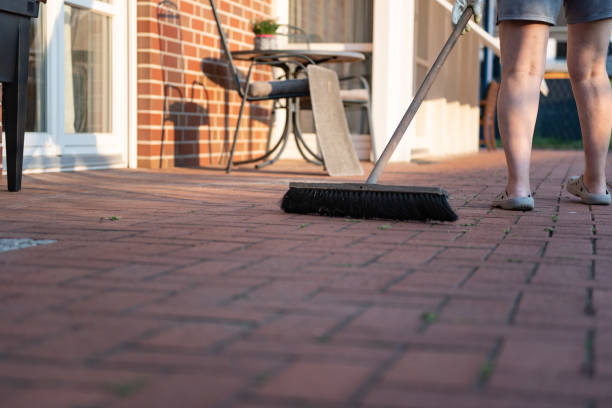 a woman is cleaning the terrace stock photo
