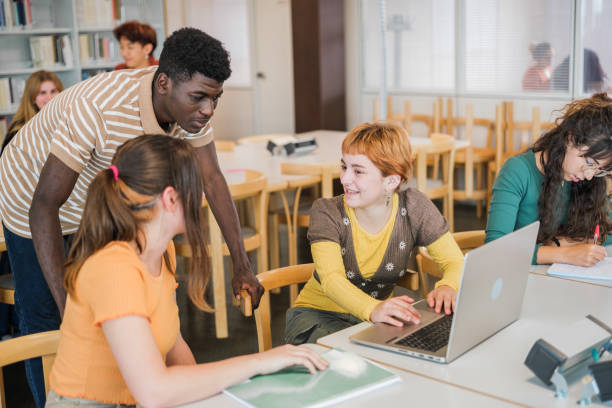 istock Group of students of different ethnicity in the university library studying together 1551213013