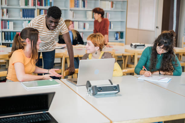 istock Students gathered in a group to do work together in the university library 1551213023
