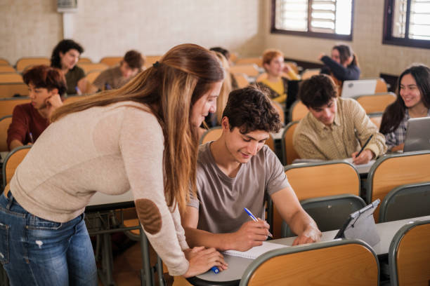 istock Teacher explaining to the student individually in a university classroom 1551214088