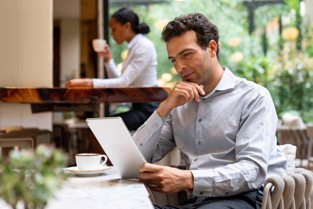 istock Successful business man working online at a cafe 1551218812