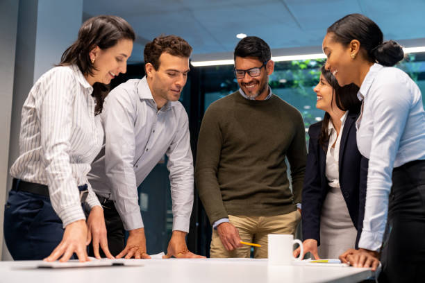 Happy group of workers sharing ideas in a business meeting