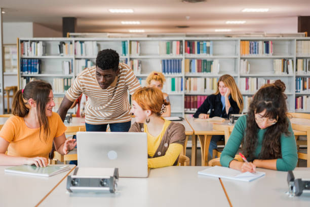 istock Group of students of different nationalities studying together in the university library 1551224829