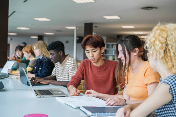 istock Group of concentrated college students while studying at the university 1551225912
