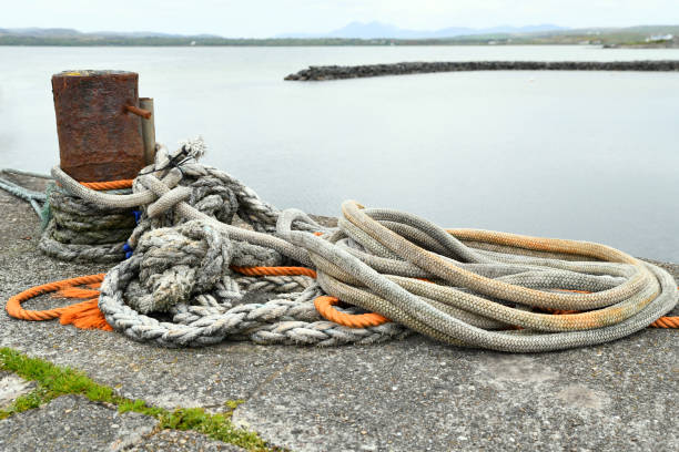 Still life with ropes and bollard on the quay, Bowmore, Isle of Islay, Scotland Bowmore (Scottish Gaelic: Bogh Mòr, 'Big Bend') is a small town on the Scottish island of Islay and is situated on the shores of Loch Indaal. It serves as administrative capital of the island, and gives its name to the noted Bowmore distillery producing Bowmore single malt scotch whisky. bowmore whisky stock pictures, royalty-free photos & images