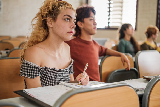 istock University students of different origins attending the teacher's explanations in class 1551235401