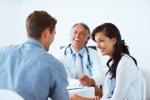 istock Mature doctor and patients having a conversation 155124424