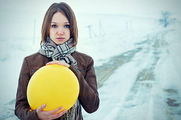 Portrait sad girl with a cheerful balloon stock photo