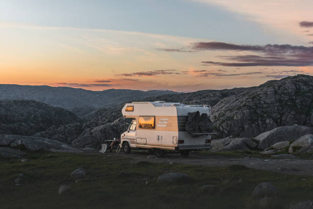 istock camper van on the mountain in the sunset sunlight, Norway 1551248627