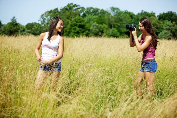 istock asian female teens in grassy summer field 155125068