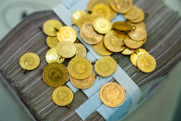 istock Gram gold coins and money stacks 1551260091