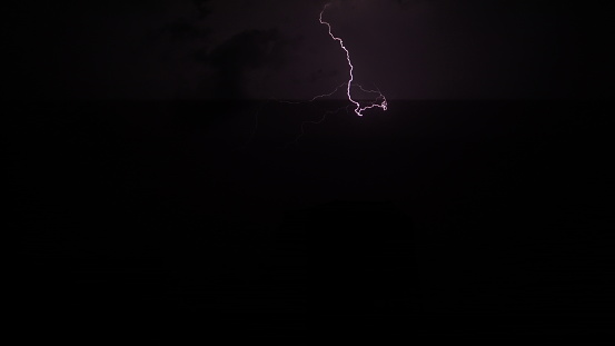 Small lightning flashes in the night sky.