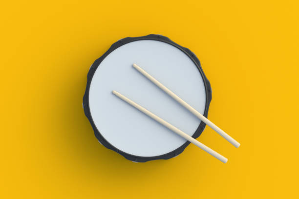 istock Drum with drumsticks on orange background. Percussion musical instrument. Top view. 3d render 1551275862