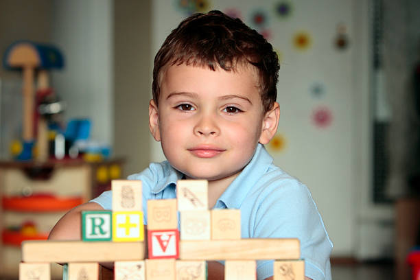 Autistic child with toy blocks stock photo