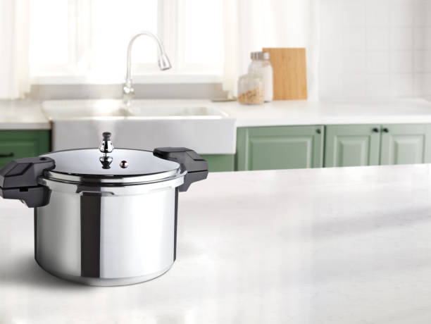 istock Pressure cooker with a steam on a marble countertop 1551286446
