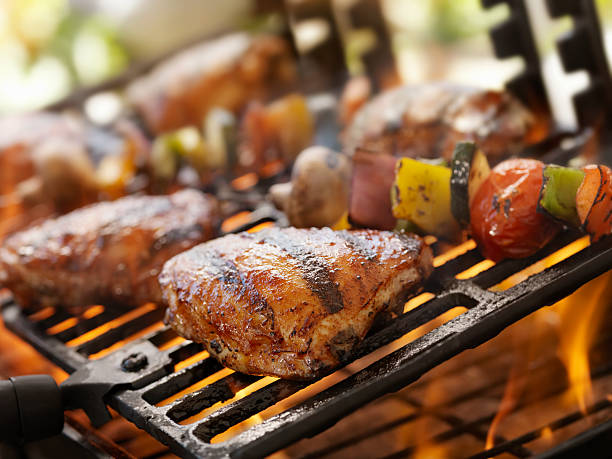 barbecue chicken - chicken thighs stock-fotos und bilder