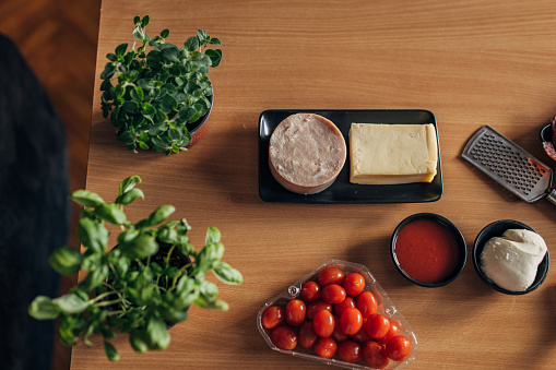 Photo of ingredients for pizza on wooden table