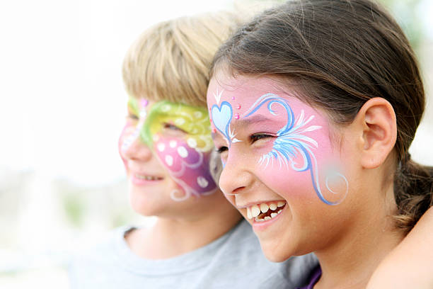 Kids with painted faces smiling stock photo