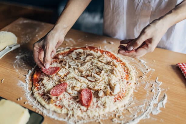 istock A woman prepares a pizza 1551295980