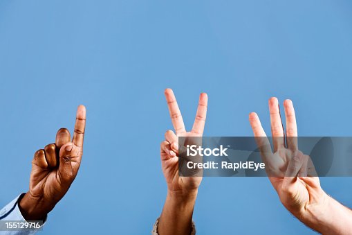 istock Mixed hands count out 1, 2, 3, against blue background 155129716