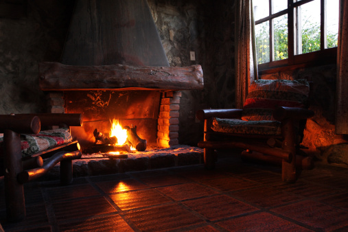 Blanket to keep warm in front of the cozy fire of the fireplace inside the house