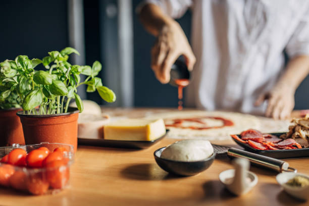 istock A woman prepares a pizza 1551301135