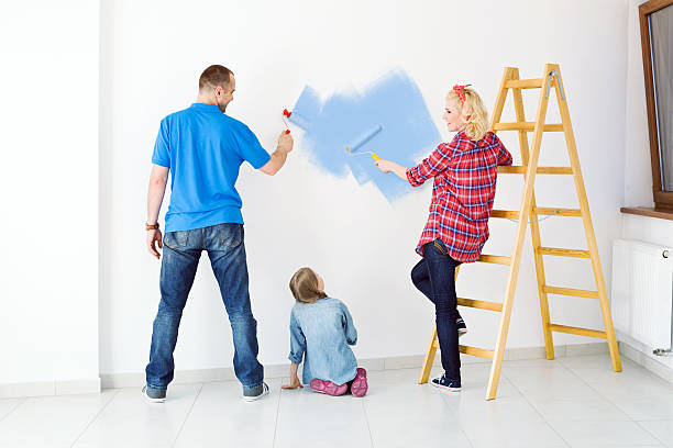 istock Happy family painting a wall 155130264