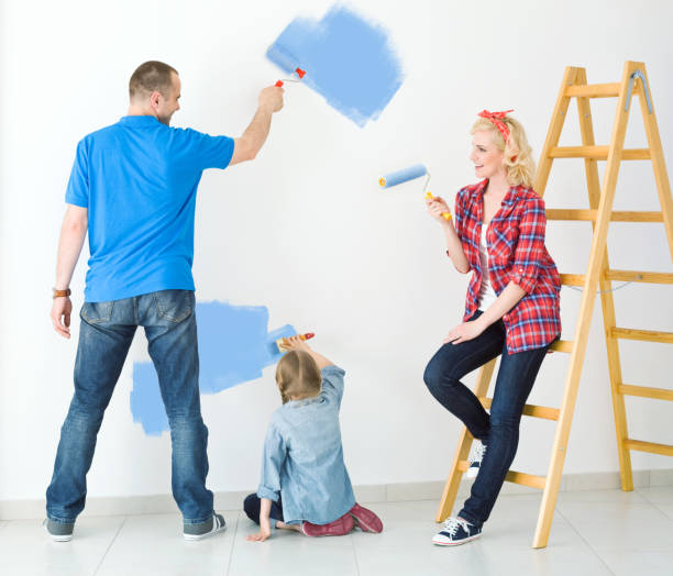 istock Happy family painting a wall 155130265