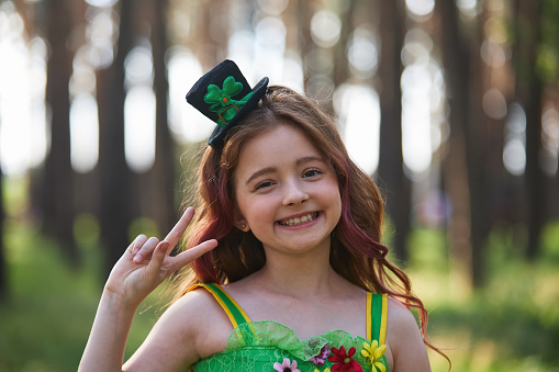 Couple of elementary age kids dressed in festive green clothes for a Saint Patrick's Day celebration on the 17th of March