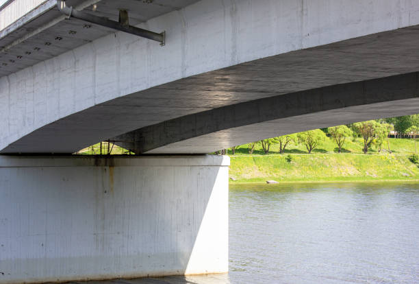 istock Reinforced concrete transport bridge across the river, bottom view. 1551306866