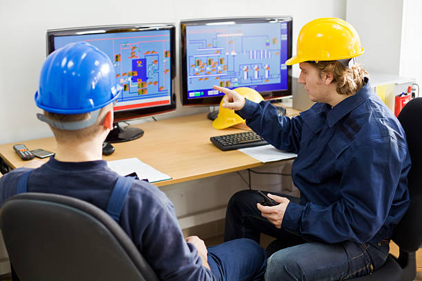 Two Workers in a Control room stock photo