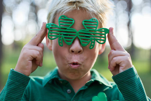 Couple of elementary age kids dressed in festive green clothes for a Saint Patrick's Day celebration on the 17th of March