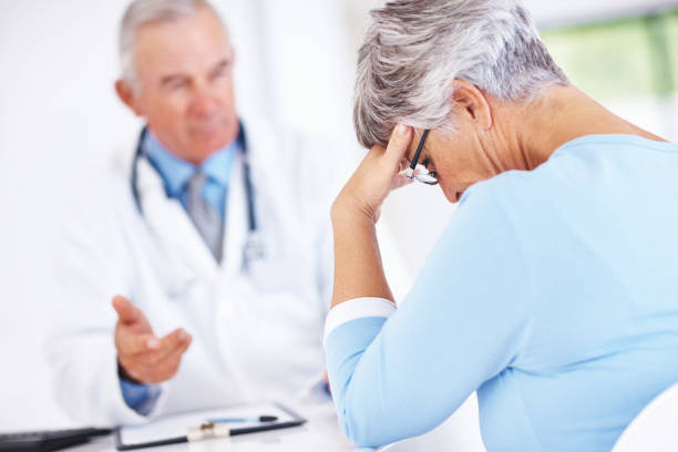 istock Mature doctor with unhappy patient 155131058